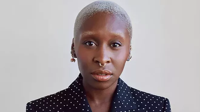 A portrait of a woman in a dark suit