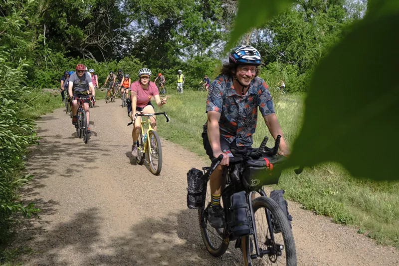 Image: Several bikers on a forested gravel path in Boulder