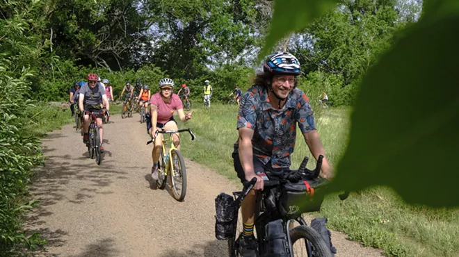 Several bikers on a forested gravel path in Boulder