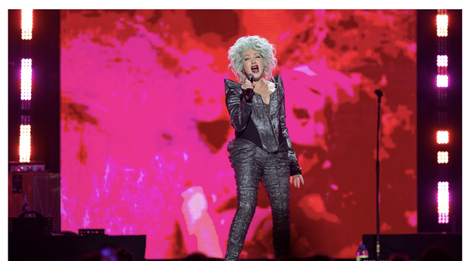 Cyndi Lauper singing on stage