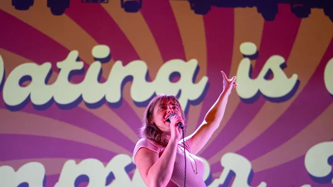 Dayna McTavish stands on stage during a prior performance of Dating is a Dumpster Fire.