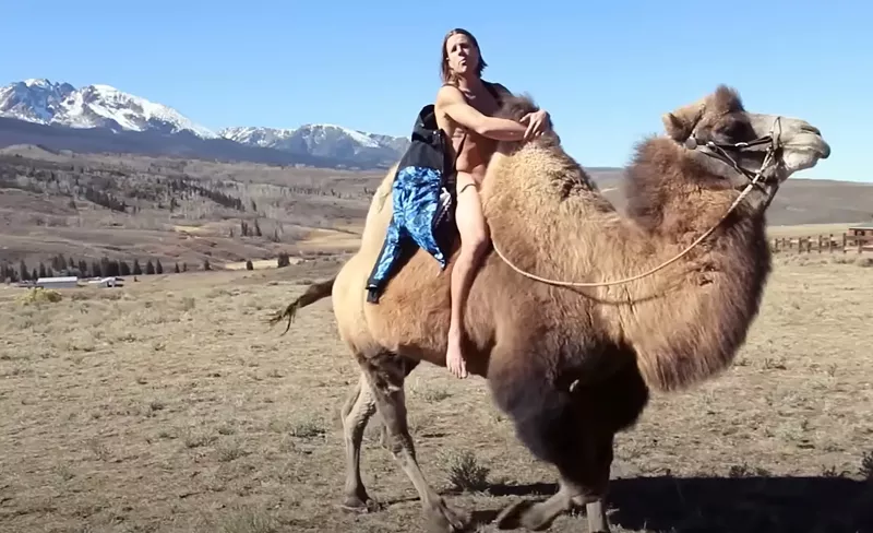 Image: man naked on camel