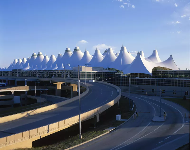 Image: denver airport with tents and blue sky