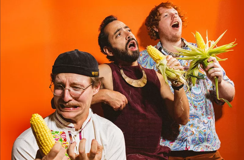 Image: three men holding corn