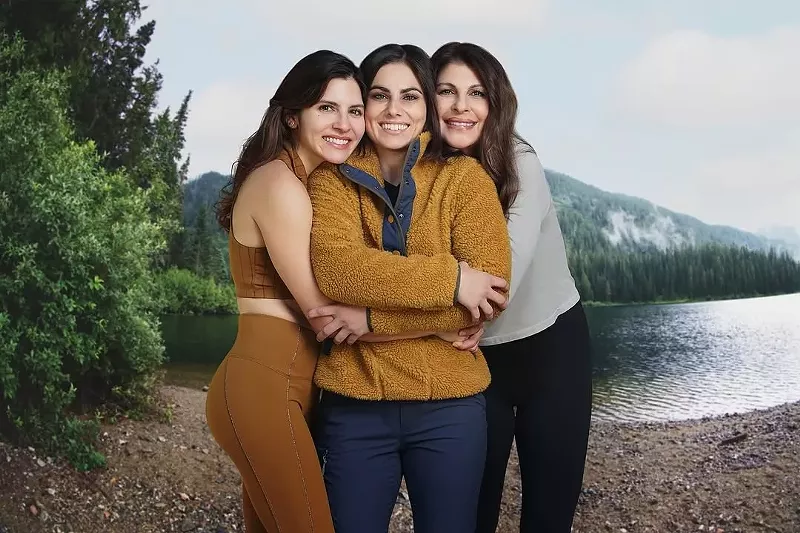 Image: three women pose in outdoor clothing and smiling to camera
