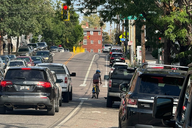 A cyclist on 11th Avenue in Capitol Hill has to hope nearby drivers don't narrow her bike lane.