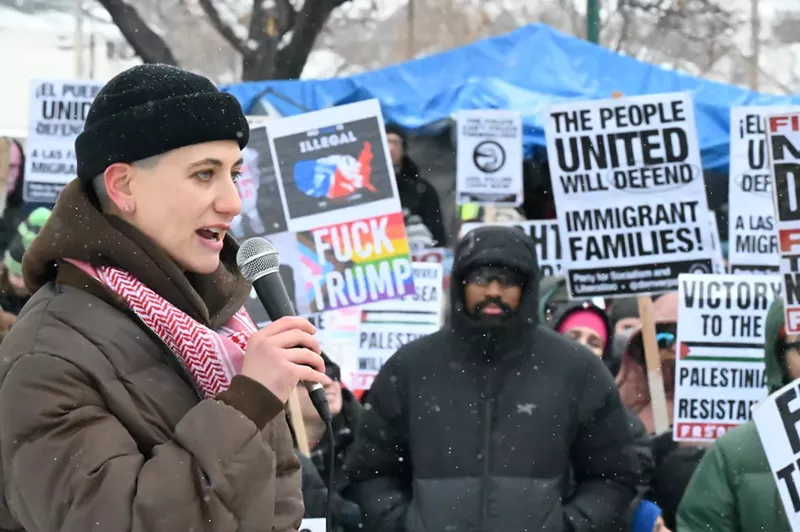 Image: A person speaks in the snow.