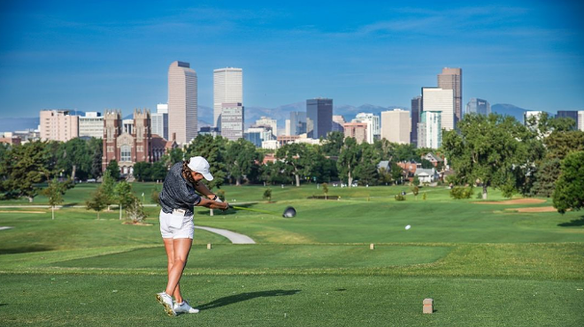 A golfer swings at City Park Golf Course in Denver