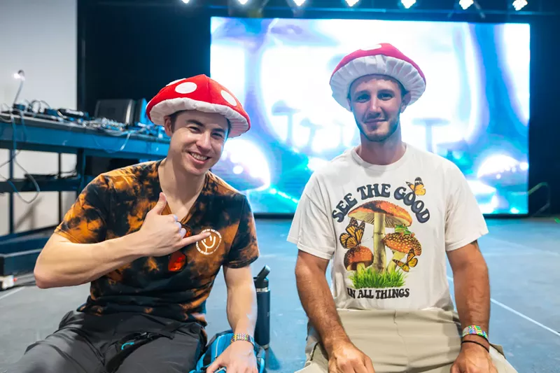 Image: Men wearing red mushroom hats