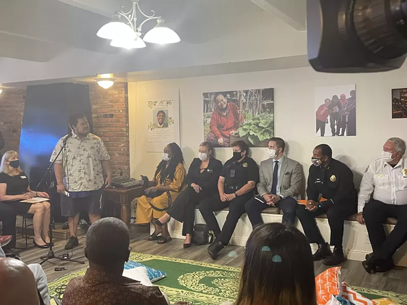 Image: Police officers and public officials at an ECNA community meeting.