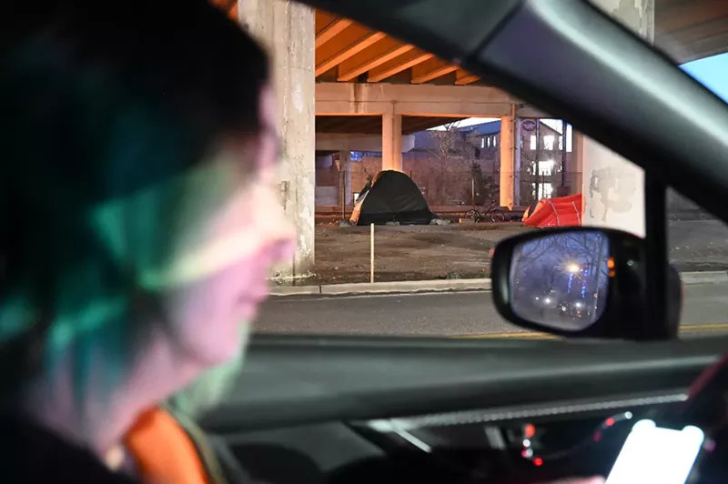 Image: The Point in Time volunteer tallies a homeless person's tent.