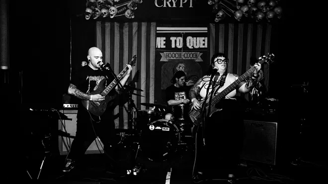 metal band poses for black and white photo