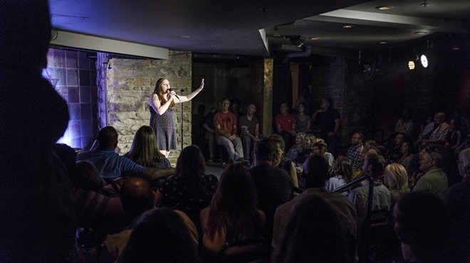 woman doing standup at a comedy club