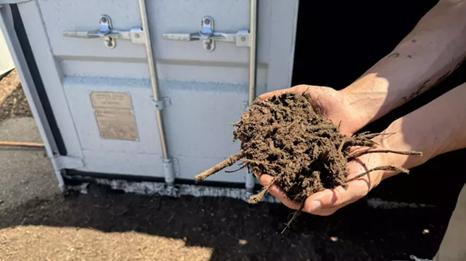 Man holds composted dirt