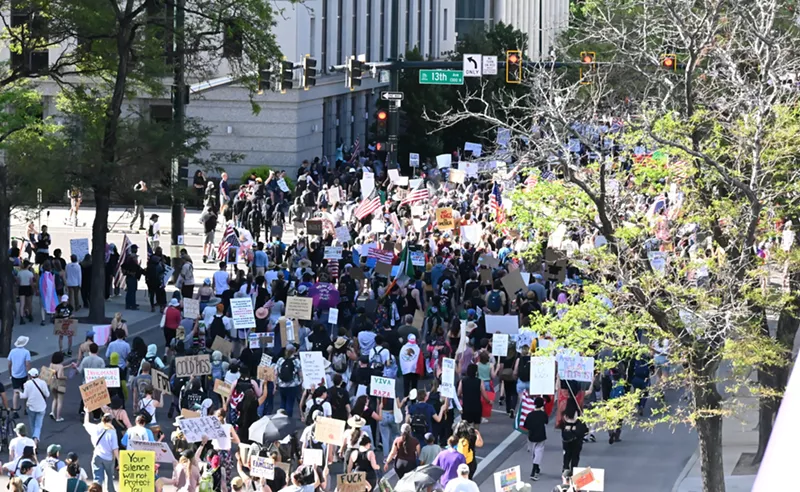Image: protesters march down Denver street