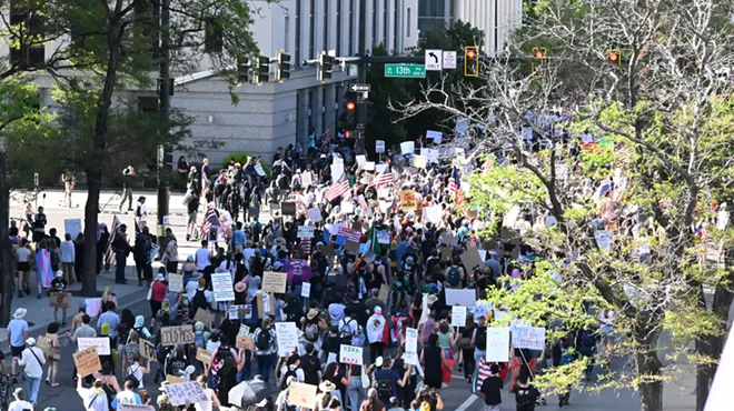 protesters march down Denver street