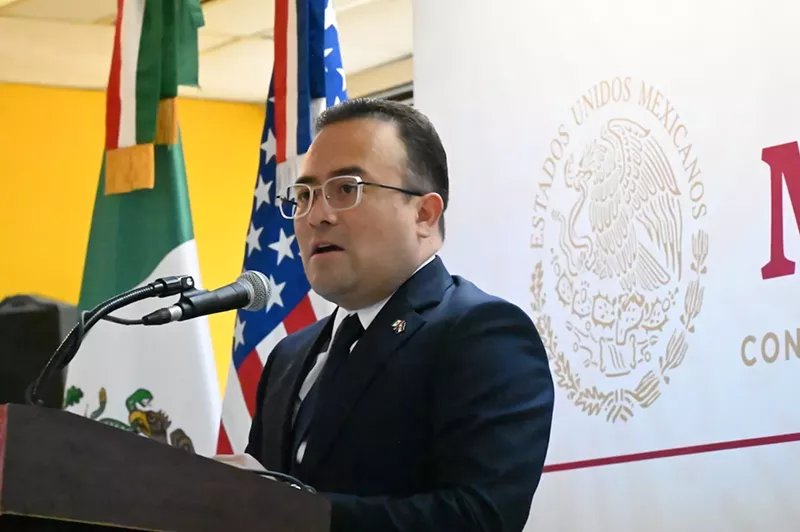 Image: Mexican Consul General in Denver Pável Meléndez Crus speaks in front of the Mexican and American flags.