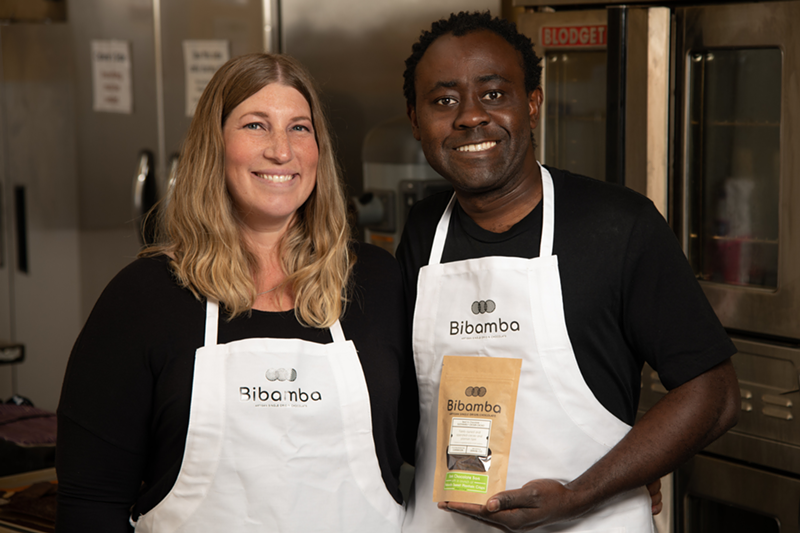 Image: Mara and Patrick Tcheunou wearing white aprons in their chocolate kitchen