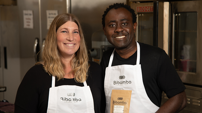 Mara and Patrick Tcheunou wearing white aprons in their chocolate kitchen