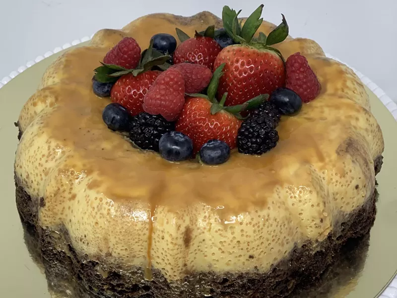 Image: a flan cake topped with berries