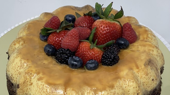 a flan cake topped with berries