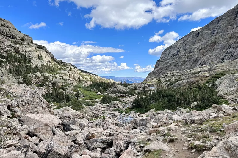 Image: A boulder-strewn valley and distant peaks in Rocky Mountain National Park