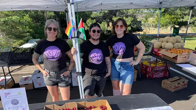 The three Common Harvest Colorado co-founders underneath a tent at a farmers market