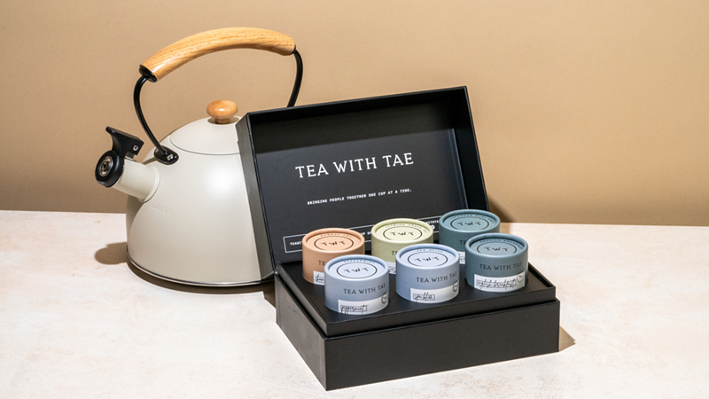 Image: A black gift box containing six tubes of tea sachets