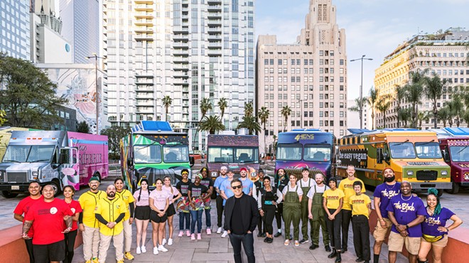 People and food trucks backdropped by LA skyscrapers