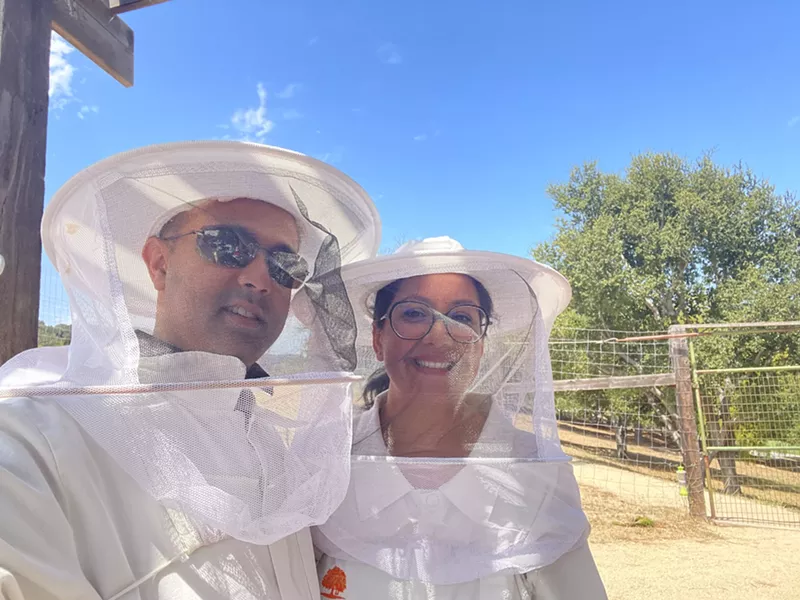 Image: Husband and wife in beekeeping gear