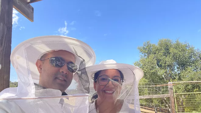 Husband and wife in beekeeping gear