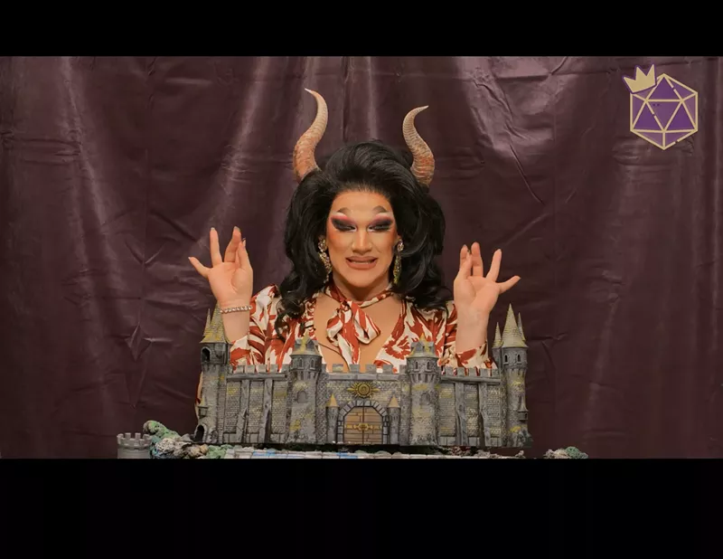Image: A drag queen with her hands raised