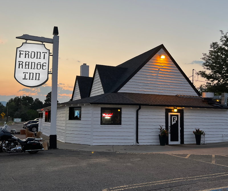 Image: white "front range inn" sign outside a small white building