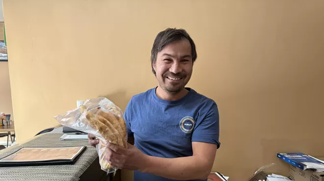 man holding bag of flatbread
