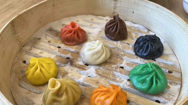 various colored dumplings in an open steamer basket