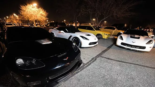 Corvettes and sports cars at a parking lot car gathering