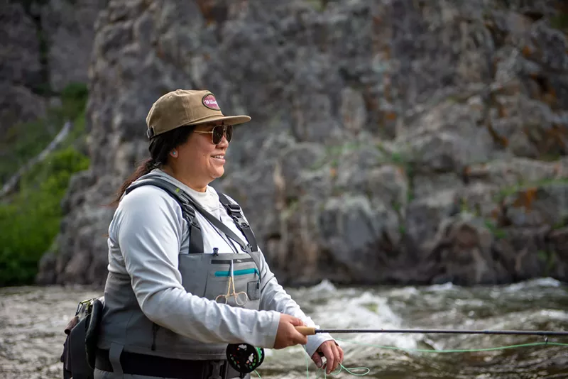 Image: woman fishing in river