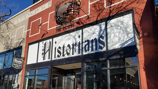 front of a brick building with a white sign