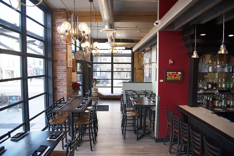 Image: tables and empty chairs inside a restaurant
