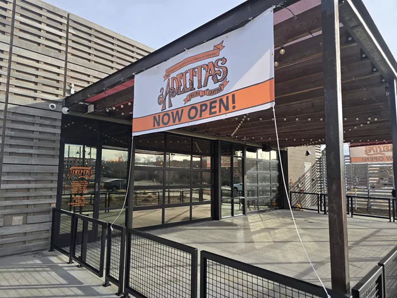 Image: "now open" sign on a building