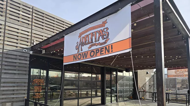 "now open" sign on a building