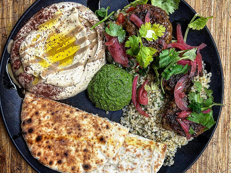 Image: a plate with pita, hummus and lamb
