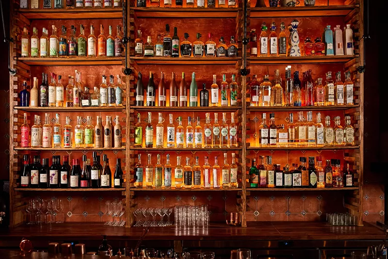 Image: shelves lined with bottles of mezcal