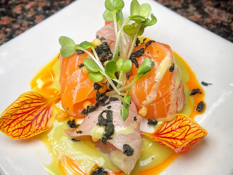 Image: raw fish with colorful garnishes on a plate