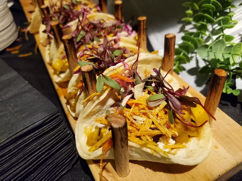 Image: tacos lined up on a board
