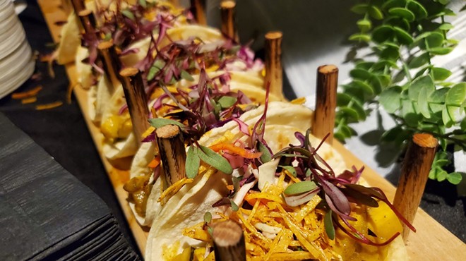 tacos lined up on a board