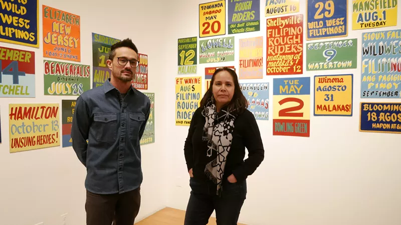 Image: man and woman in front of gallery images