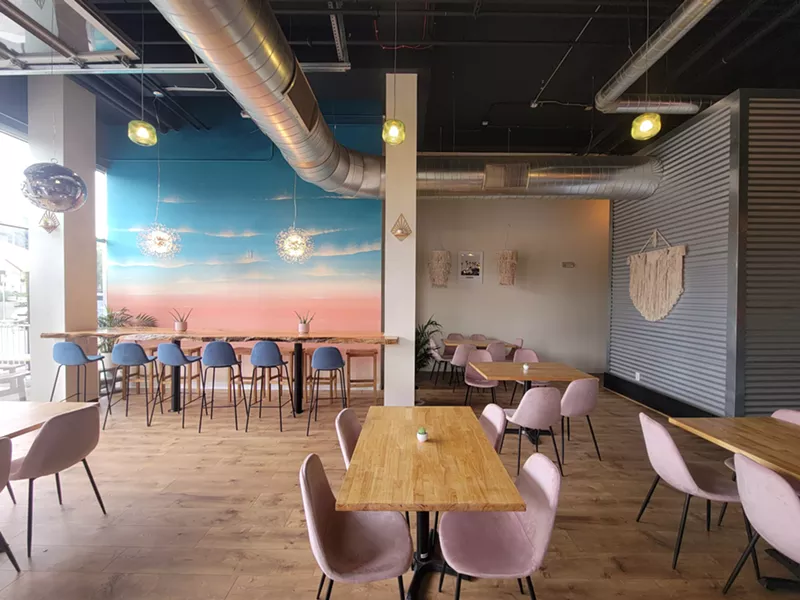 Image: colorful dining room with chairs and mural