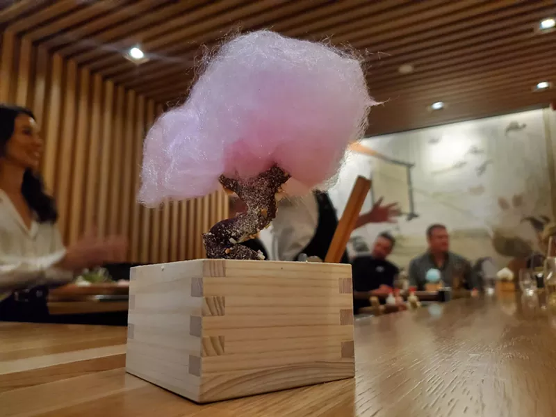 Image: a tree made with a chocolate covered pretzel trunk and cotton candy