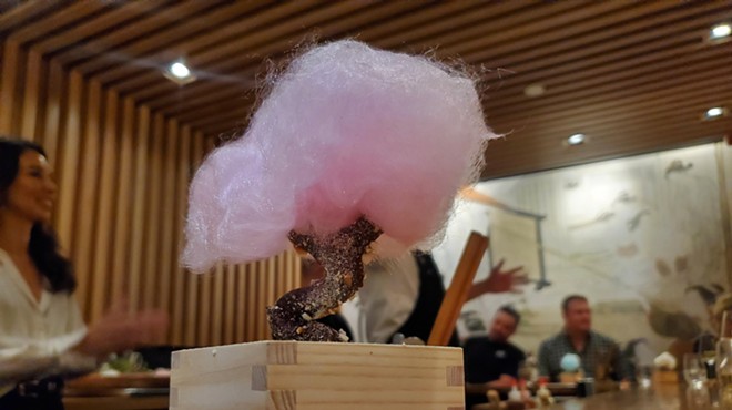a tree made with a chocolate covered pretzel trunk and cotton candy